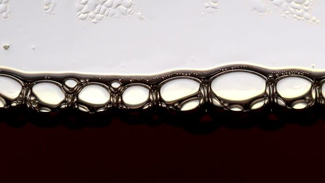 Tokyo,Japan - June 6, 2022: Closeup of drip coffee water droppping into jug container with bubble.
