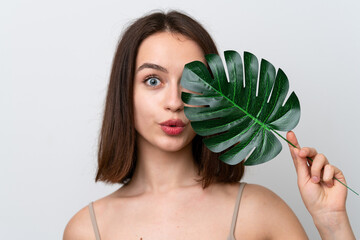 Young Ukrainian woman isolated on white background holding a palm leaf. Close up portrait