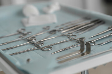 Fototapeta premium Surgical instruments and tools including scalpels forceps and tweezers arranged on table for surgery