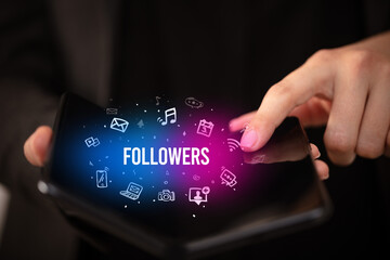 Businessman holding a foldable smartphone, social media concept