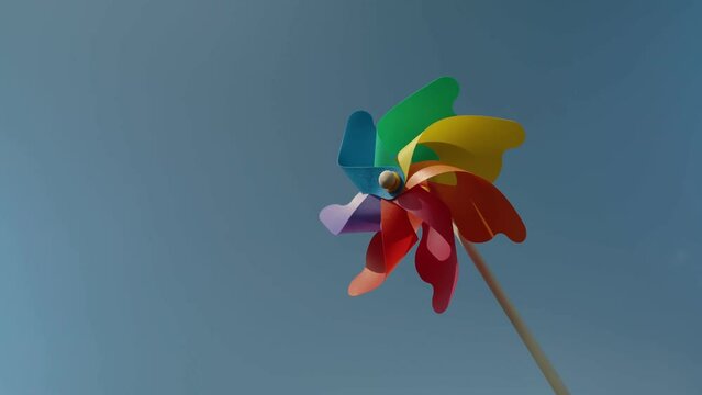 colorful paper windmill against the blue sky