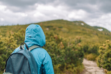 Man and 50s woman hiking on wet rocks at mountain. Babia Góra Poland