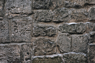 Texture of grunge stone wall. Natural surface. Vintage background of large gray sandstone and granite blocks.