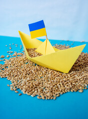 grain wheat and spikelets on a blue background. Ukrainian grain and problems of blockade of ports