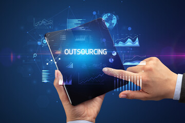 Businessman holding a foldable smartphone, business concept