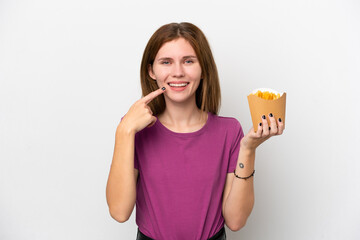 Young English woman holding fried chips isolated on white background giving a thumbs up gesture