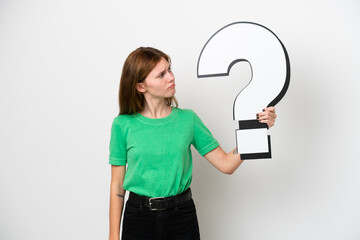 Young English woman isolated on white background holding a question mark icon and having doubts