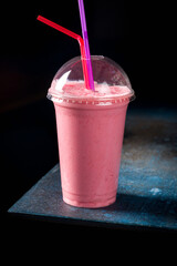 strawberry milkshake on dark style on dark blue table
