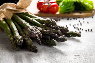 a bunch of fresh asparagus on grey table macro close up
