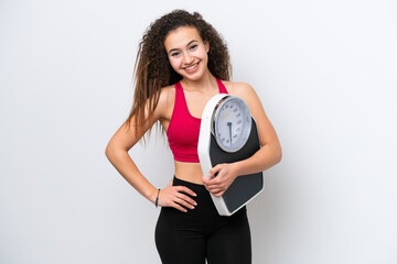 Young Arab woman isolated on white background with arms at hip and holding weighing machine
