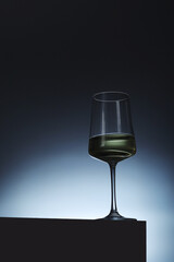 White wine in a transparent glass in low key