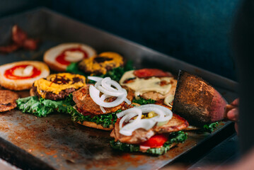 Unknown person preparing some delicious hamburgers on a griddle 