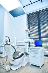 Dentist office with laptop and dental intraoral scanner on table.