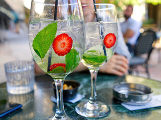 Exotic cocktail with strawberries and mint in a greece restaurant. close up