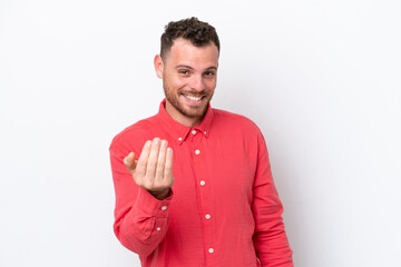 Young Brazilian man isolated on white background inviting to come with hand. Happy that you came