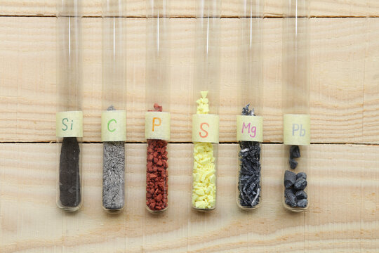 Chemical elements, simple substances non-metals and metals in test tubes: amorphous silicon, gray carbon, crystalline red phosphorus, yellow crystalline sulfur, magnesium, heavy lead.