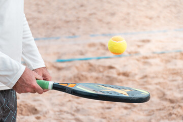 Beach tennis rackets and balls on the beach sand
