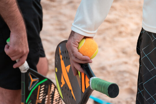 Beach tennis rackets and balls on the beach sand