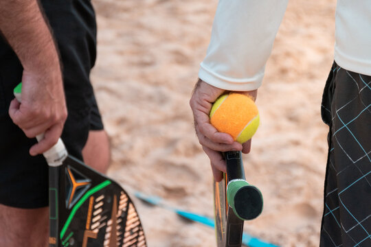 Beach tennis rackets and balls on the beach sand