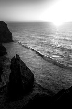 View of the Atlantic ocean and cliffs, Portugal. Black and white photo.