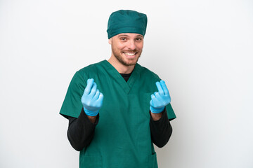 Surgeon Brazilian man in green uniform isolated on white background making money gesture