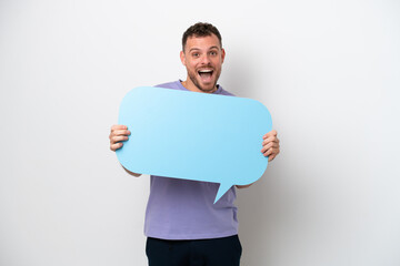 Young Brazilian man isolated on white background holding an empty speech bubble with surprised expression
