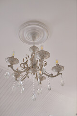 Ceiling luminous chandelier in the interior