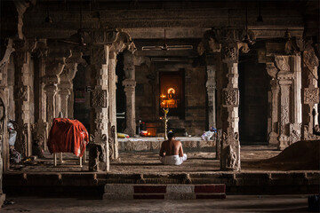 TIRUCHIRAPALLI , INDIA - FEBRUARY 15, 2013:  Unidentified Indian brahmin (traditional Hindu society) priest praying in Hindu temple Tiruchirapalli Rock Fort, Tamil Nadu, India