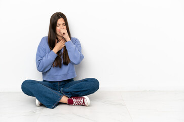 Young woman sitting on the floor is suffering with cough and feeling bad