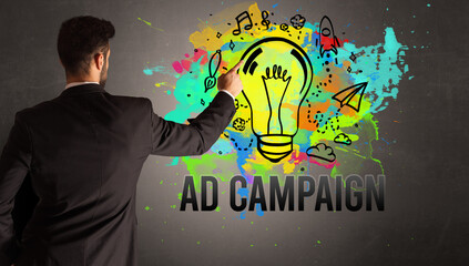 businessman drawing colorful light bulb