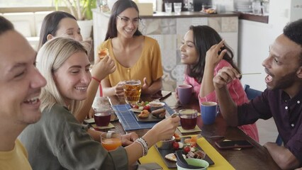 Slow motion Cheerful multiethnic Friends in the terrace bar Pub. Drinking beer, talking, having fun. Friendship and happy community concept