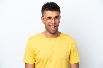 Young Brazilian man isolated on white background With glasses and happy expression