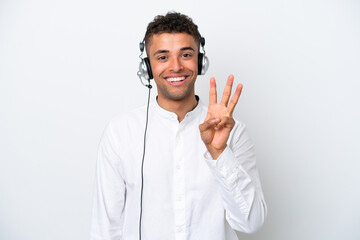 Telemarketer Brazilian man working with a headset isolated on white background happy and counting three with fingers