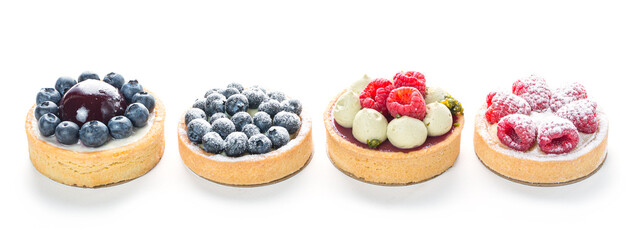 Delicious cakes with fresh berries - blueberries, raspberries isolated on white background