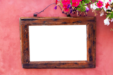 Vintage old retro wooden frame on pink red wall with flowers. Design mockup