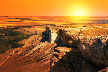 Rocky landscape at sunset. The sun sets over the valley.