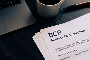 There is dummy documents that created for the photo shoot on the desk about Business Continuity Plan.