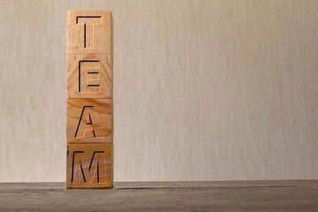 team engraved on wooden cubes on a blurred background