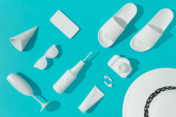 Creative layout with various summer objects on pastel blue background. Minimal vacation concept. Flat lay.