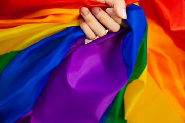 Flag of pride. LGBTQ and lgbtq+ flag and hand symbol of Lesbian Gay Bi sexsual Transgender Queer or homosexsual pride Rainbow flag. black background. Represent hand symbol of freedom equality.