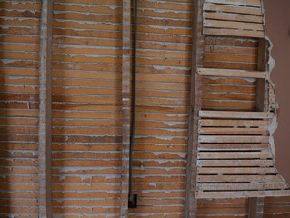 Plaster and lath walls that make great construction and grunge texture for backgrounds or old house photos