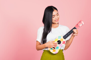 Portrait of happy Asian beautiful young woman teen confident smiling face hold acoustic Ukulele...