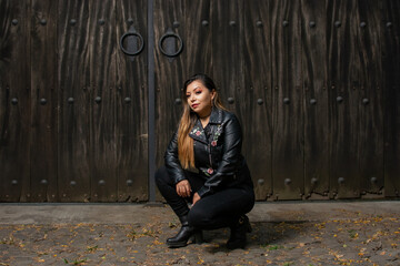 Portrait of young woman in biker jacket.