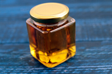 Honey in a cosmetological jar on the table