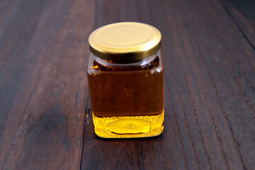 Honey in a cosmetological jar on the table