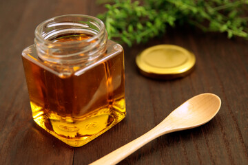 Honey in a cosmetological jar on the table