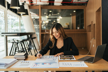 Business woman working in office with documents, Businesswoman reading financial graph charts business info.