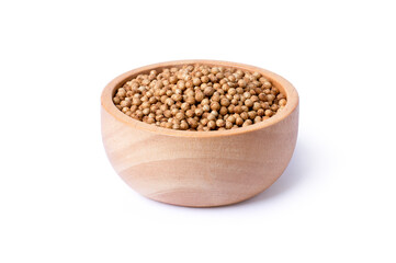 Coriander seeds in wooden bowl on a white background