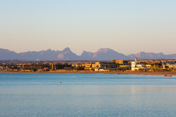 Egypt coastline. Sunset on the seashore. Coastline overlooking hotels and mountains. Sunset in the...