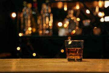 Barman pouring whiskey glass beautiful night